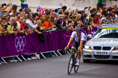 Olympic cyclist with safety barriers in background